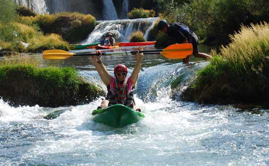 kayaking through rapids